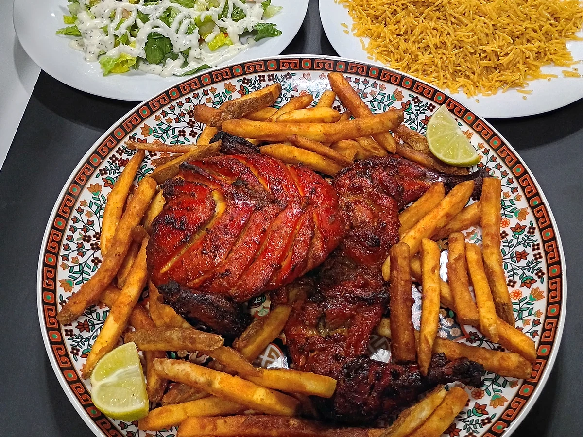 Whole charcoal chicken feast with fries, naan, salad and rice